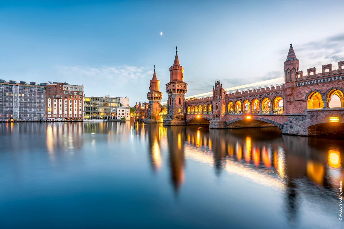 Oberbaum Bridge over the Spree River in Berlin at dusk.