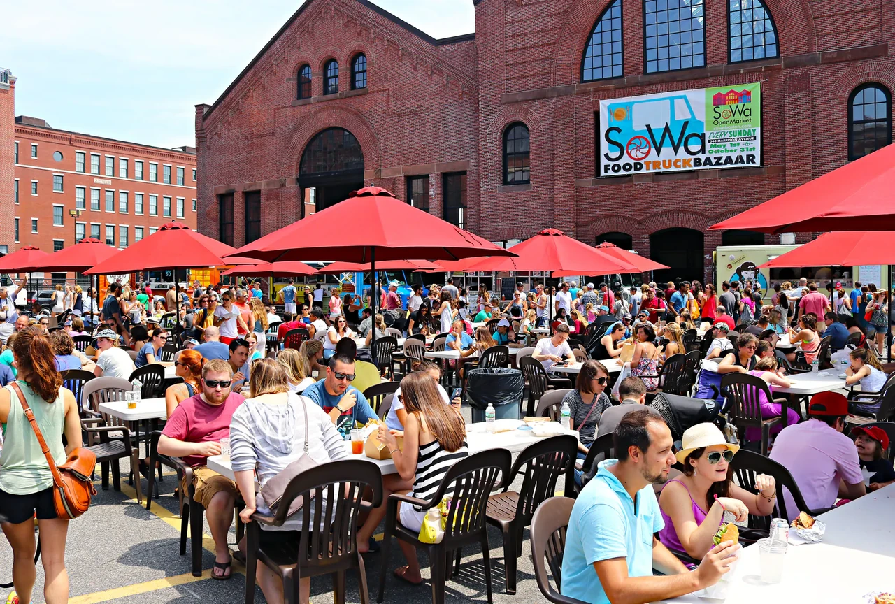 Market stalls and food trucks during SoWa market season in Boston