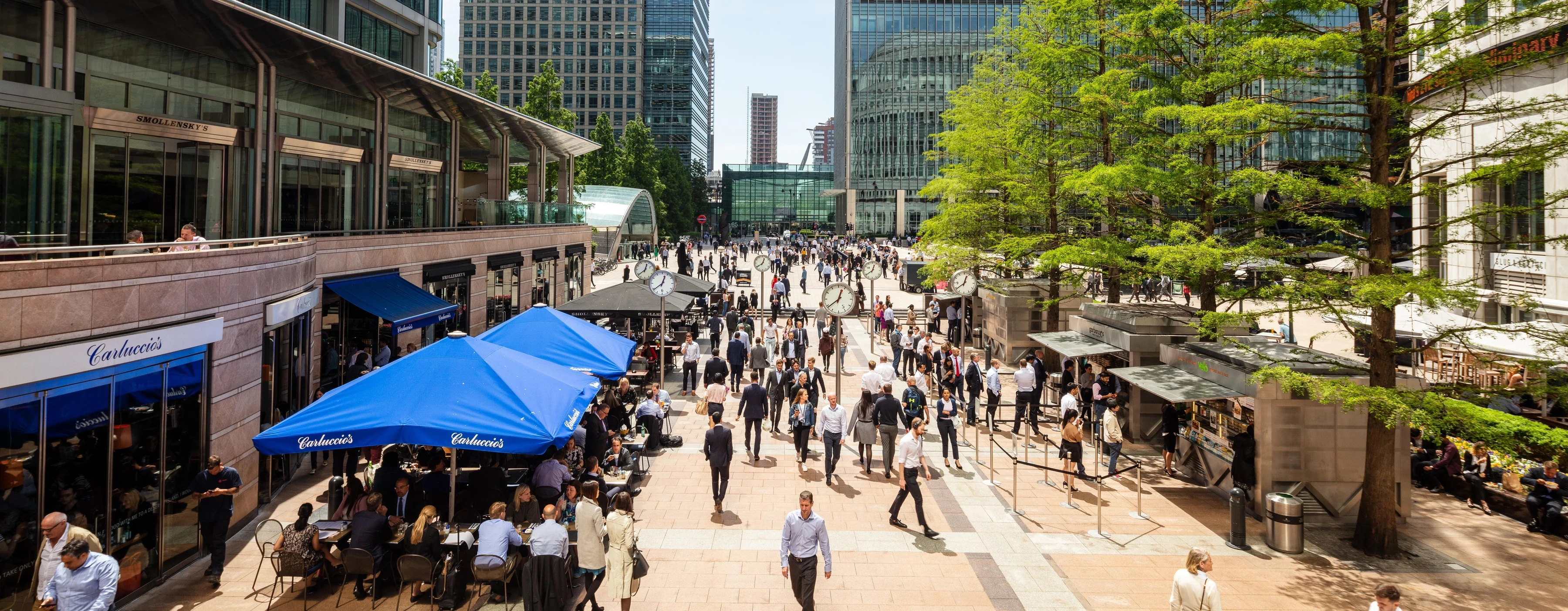 Canary Wharf promenade with restaurants and office workers in London