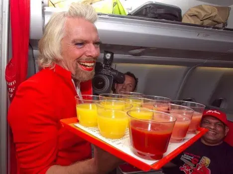 Branson serves as AirAsia stewardess after losing bet